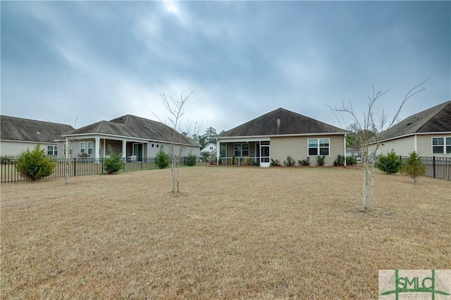 back of house featuring a lawn