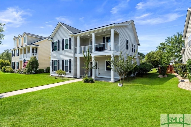 view of front of property with a balcony and a front yard