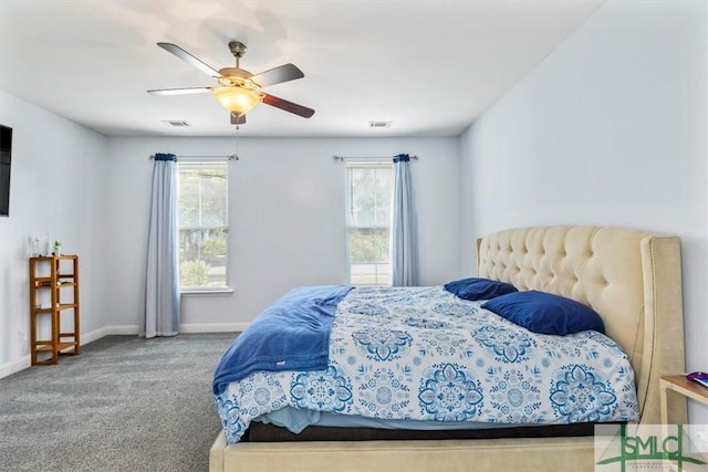 carpeted bedroom featuring multiple windows and ceiling fan