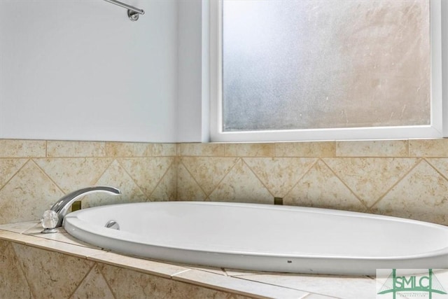 bathroom featuring tiled bath