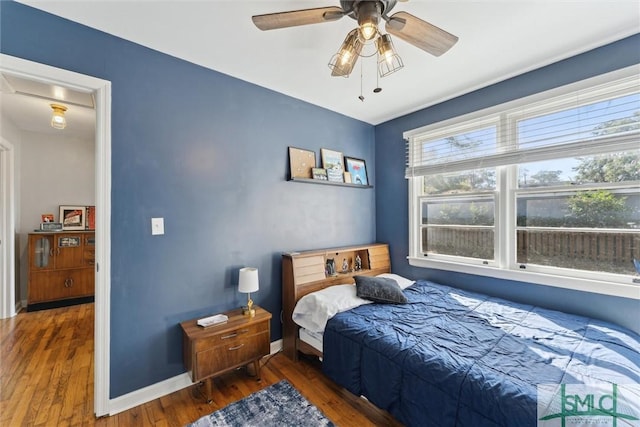 bedroom featuring dark hardwood / wood-style floors and ceiling fan