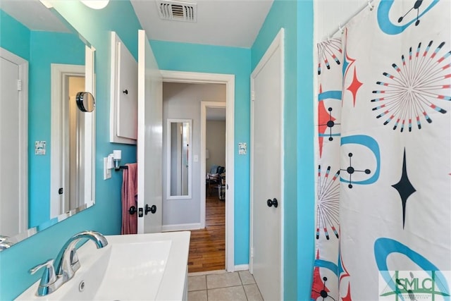 bathroom featuring sink, tile patterned floors, and a shower with shower curtain