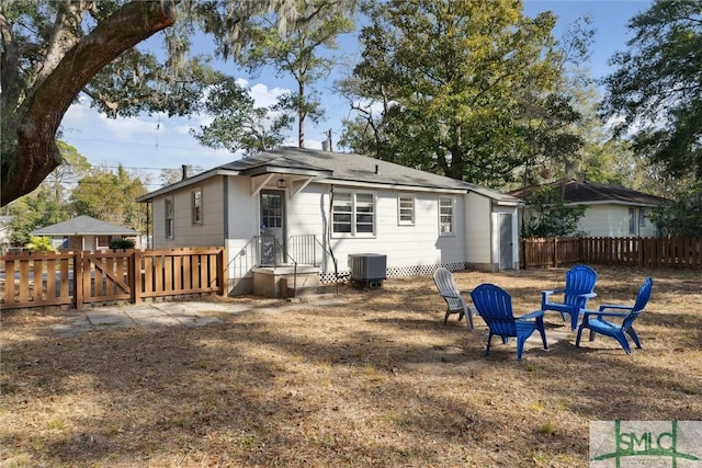 rear view of property with central AC unit