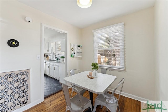 dining room featuring sink and light hardwood / wood-style flooring