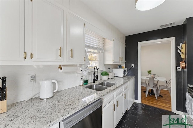 kitchen with sink, white cabinets, and dishwasher