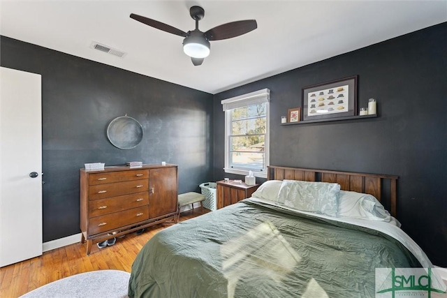 bedroom with light hardwood / wood-style floors and ceiling fan