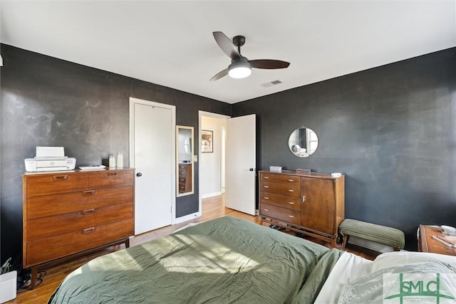 bedroom with wood-type flooring and ceiling fan