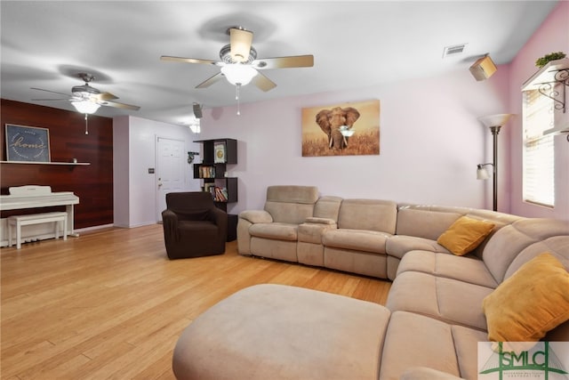living room with ceiling fan and light wood-type flooring