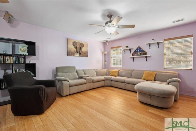 living room with ceiling fan and light hardwood / wood-style floors