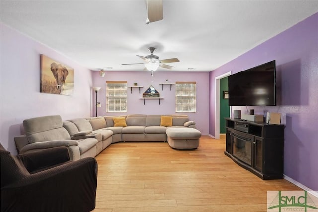 living room featuring ceiling fan and light hardwood / wood-style floors