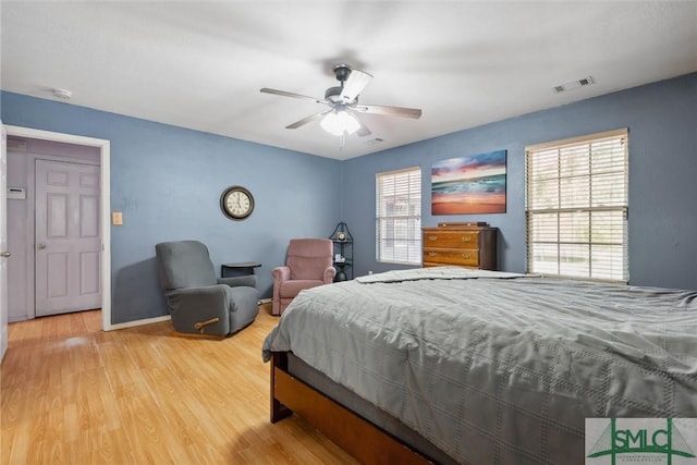 bedroom with hardwood / wood-style floors and ceiling fan