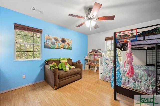 bedroom with ceiling fan and light wood-type flooring