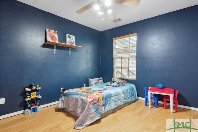bedroom featuring hardwood / wood-style flooring and ceiling fan