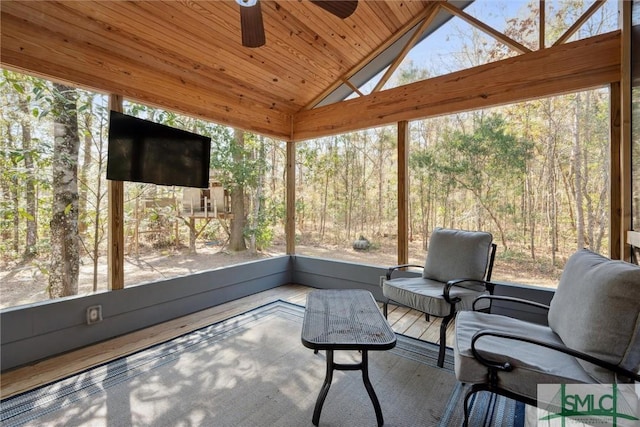 sunroom / solarium with wood ceiling, vaulted ceiling, and ceiling fan