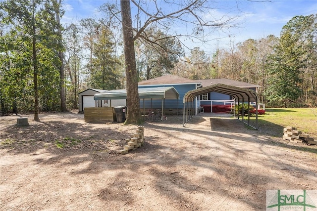 exterior space with a carport and a garage