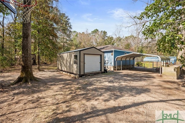 exterior space with a carport and an outdoor structure