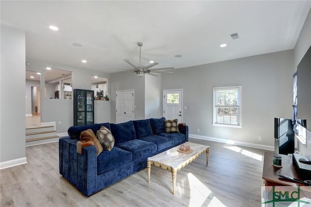 living room with ceiling fan and light hardwood / wood-style floors