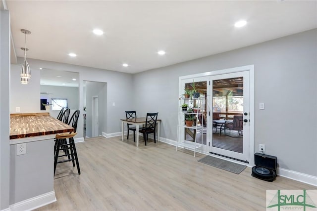 dining area featuring a healthy amount of sunlight and light hardwood / wood-style floors