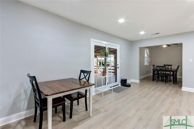 dining room with ceiling fan and light hardwood / wood-style flooring