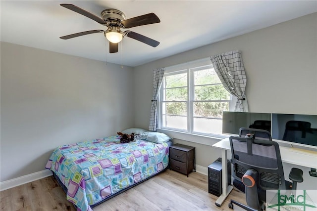 bedroom with light hardwood / wood-style flooring and ceiling fan