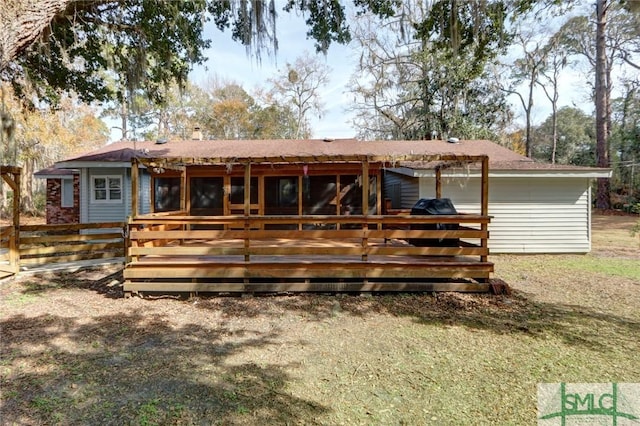 rear view of property featuring a wooden deck