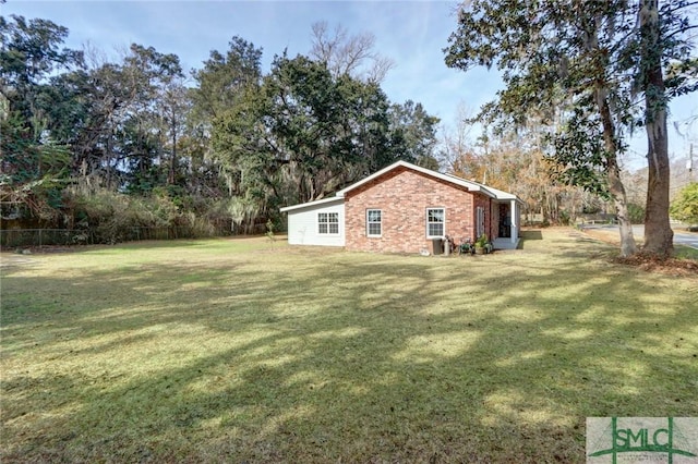 view of side of home with a lawn