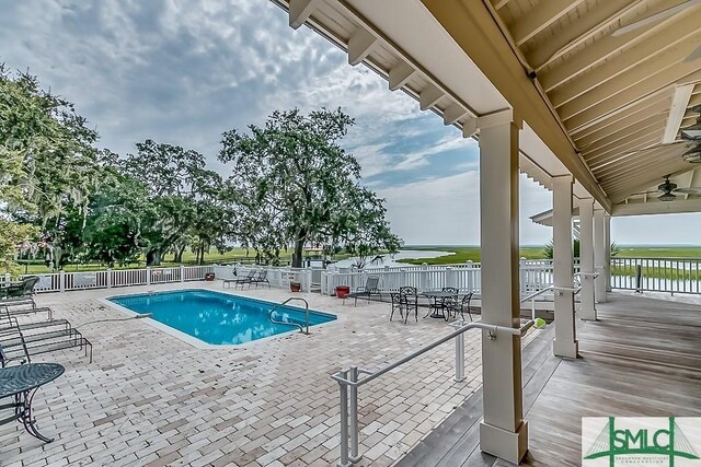 511 Goodman Dr, Midway, GA 31320 - community pool with ceiling fan, a water view, and a patio area