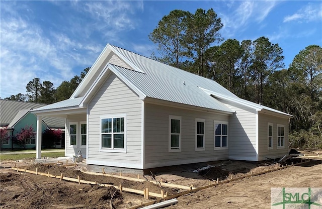 view of side of home featuring metal roof