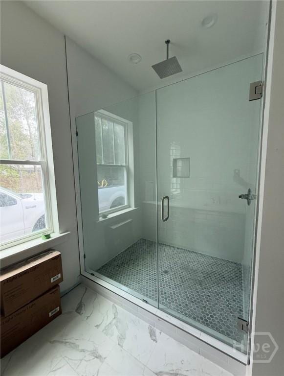 511 Goodman Dr, Midway, GA 31320 - bathroom featuring marble look tile flooring and a stall shower