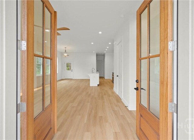511 Goodman Dr, Midway, GA 31320 - hall featuring french doors, light wood-type flooring, recessed lighting, and baseboards