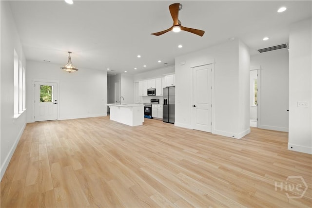 511 Goodman Dr, Midway, GA 31320 - unfurnished living room with light wood finished floors, baseboards, a sink, a ceiling fan, and recessed lighting