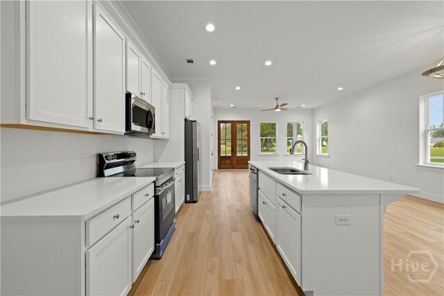511 Goodman Dr, Midway, GA 31320 - kitchen featuring appliances with stainless steel finishes, a sink, light countertops, white cabinetry, and recessed lighting