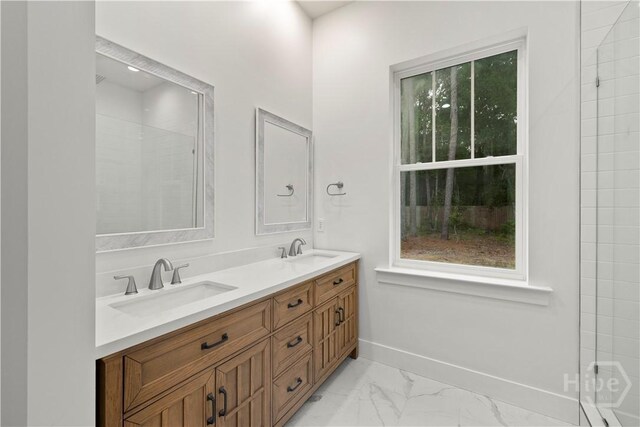 511 Goodman Dr, Midway, GA 31320 - full bathroom featuring double vanity, baseboards, and marble look tile flooring