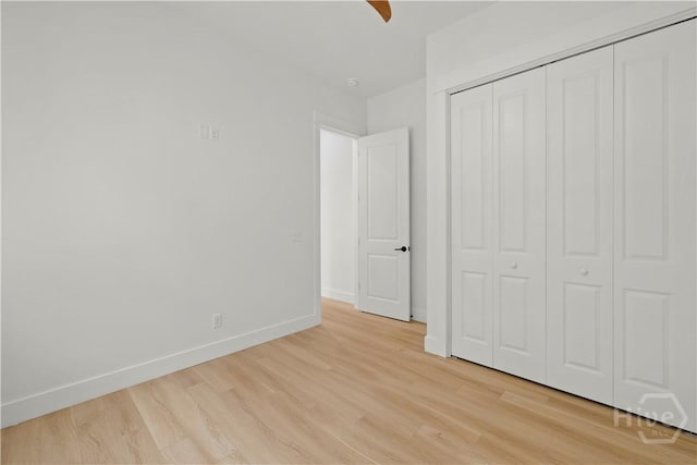 511 Goodman Dr, Midway, GA 31320 - unfurnished bedroom with light wood-type flooring, baseboards, a closet, and a ceiling fan