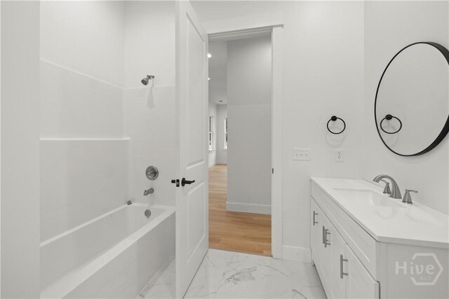 511 Goodman Dr, Midway, GA 31320 - bathroom featuring marble finish flooring, vanity, shower / washtub combination, and baseboards