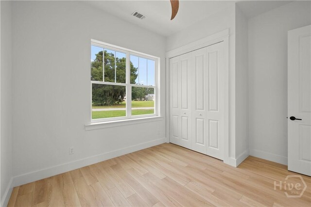 511 Goodman Dr, Midway, GA 31320 - unfurnished bedroom featuring baseboards, light wood-type flooring, a closet, and ceiling fan