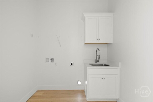 511 Goodman Dr, Midway, GA 31320 - laundry room with washer hookup, baseboards, light wood-type flooring, hookup for an electric dryer, and bar with sink
