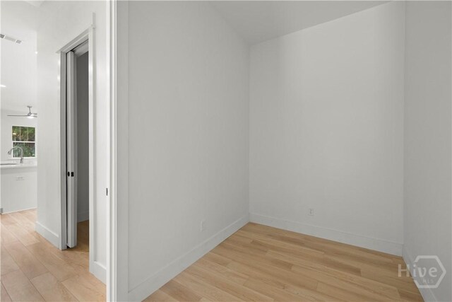 511 Goodman Dr, Midway, GA 31320 - empty room with light wood-style floors, a sink, and baseboards