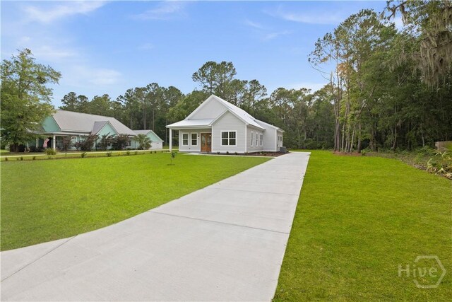 511 Goodman Dr, Midway, GA 31320 - view of front of property featuring concrete driveway and a front lawn