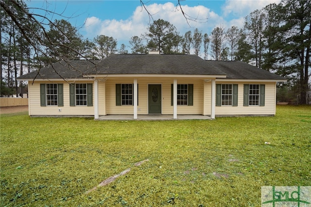 rear view of property featuring a patio area and a lawn