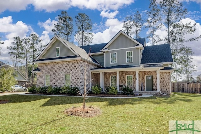 view of front of property with covered porch and a front yard