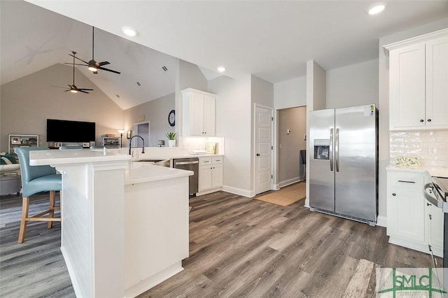 100 Sweetwater Cir, Rincon, GA 31326 - kitchen with sink, white cabinetry, a kitchen breakfast bar, stainless steel appliances, and kitchen peninsula