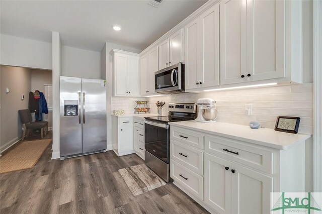 100 Sweetwater Cir, Rincon, GA 31326 - kitchen featuring stainless steel appliances, dark hardwood / wood-style flooring, decorative backsplash, and white cabinets