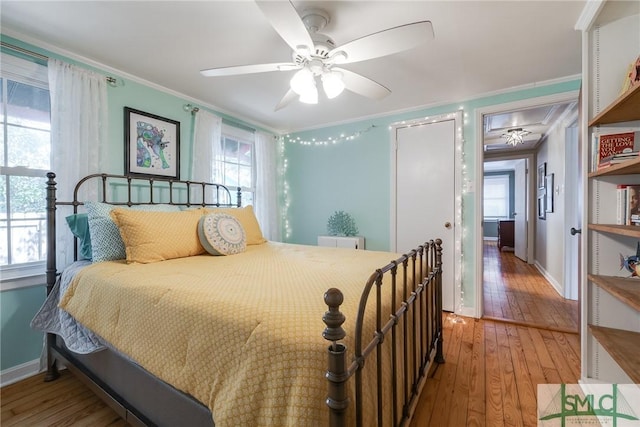 115 2nd Ave, Tybee Island, GA 31328 - bedroom with light wood-type flooring, ornamental molding, and a ceiling fan