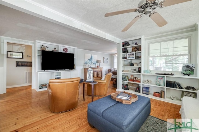 115 2nd Ave, Tybee Island, GA 31328 - living area featuring a textured ceiling, a ceiling fan, and wood finished floors
