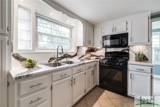 115 2nd Ave, Tybee Island, GA 31328 - kitchen with black appliances, light countertops, and healthy amount of natural light