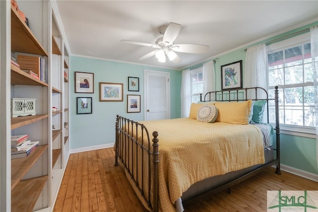 115 2nd Ave, Tybee Island, GA 31328 - bedroom with ornamental molding, multiple windows, wood finished floors, and a closet