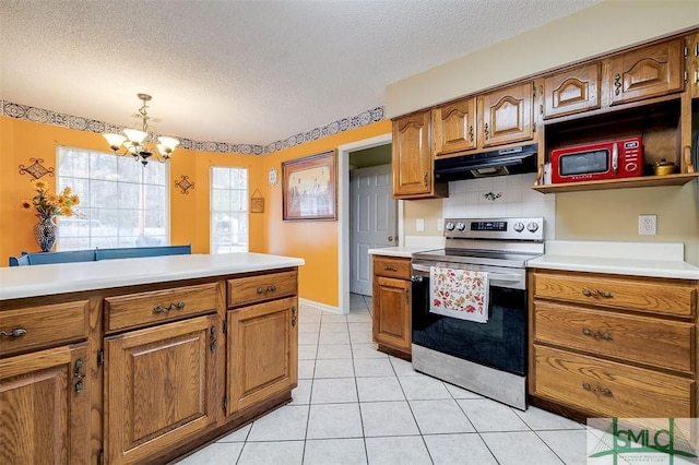 kitchen featuring extractor fan, tasteful backsplash, decorative light fixtures, a textured ceiling, and electric stove