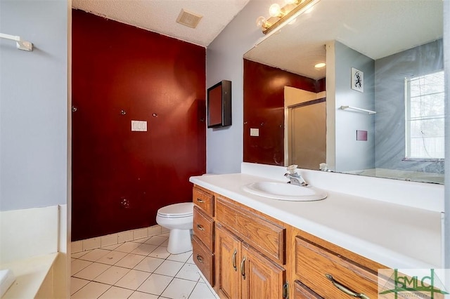 bathroom with a bathtub, vanity, a textured ceiling, tile patterned floors, and toilet