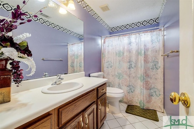 bathroom with tile patterned flooring, vanity, walk in shower, and toilet